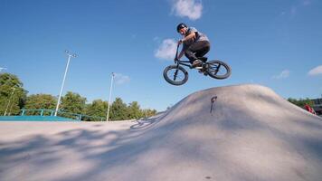 A man on a bike doing a trick on a ramp video