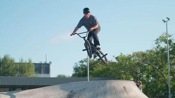 A man on a bike doing a trick on a ramp video