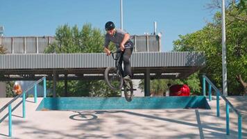 A man on a bike doing a trick on a ramp video