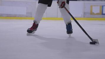 A person is standing on an ice rink with a hockey stick video
