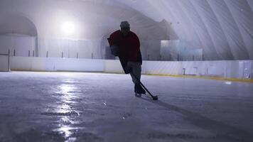 An ice hockey player is skating on the ice video