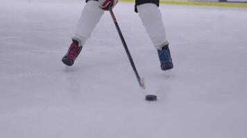 A person is skating on an ice rink with a hockey stick video