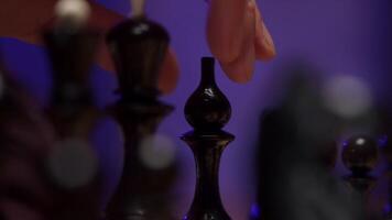 A person is playing chess with a black piece video