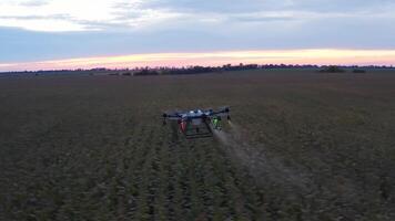 A drone is spraying a field with a crop video