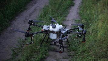 A drone is flying over a field with a hose attached to it video