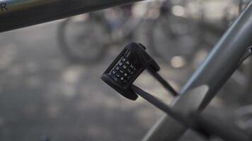 Securing bicycles against theft or stealing. Close-up of a folding metal combination lock on a bike. Cycle padlock with a password with four digits. Vehicle antitheft device for bicycles. video