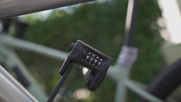 Close-up of bicycle folding lock with number combination security on cycle. Individually configurable code. Protect bicycles from burglary and theft. lock opened four-digit numerical code. video