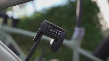Protect bicycles from stolen or hijacked. Close-up of the code folding metal lock on the bicycle. Bike security lock with a four digit password segmented lock. Vehicle antitheft tool for bicycles. video