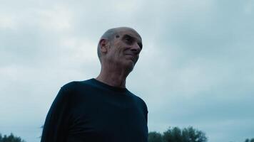 Smiling Man Swings His Head In The Evening With Cloudy Sky video