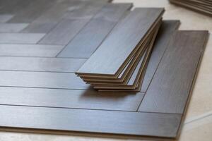 Professional laminate flooring installation in a bright apartment. Wood planks photo