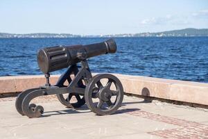 A historical cannon is placed against the scenic backdrop of Lake Onega, highlighting Petrozavodsk's rich history and cultural significance photo