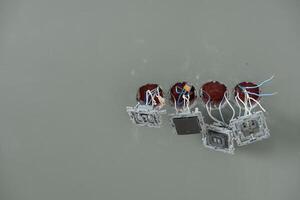 Several circuit board components with exposed wires are seen buoyantly resting on the tranquil water's surface photo