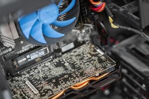 A close-up view of a computer's internal components highlighting the graphics card and cooling system during a routine check-up photo