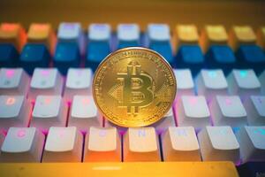 Golden Bitcoin on a Colorful Keyboard. photo