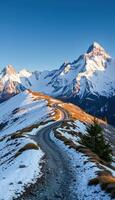 A road winding through a snowy mountain range photo