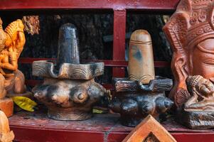 Clay figurines and statues of lingam in souvenir shop in Vietnam in Asia photo