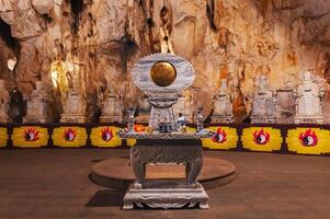 Buddhist temple with statues and sanctuary inside Am Phu Cave in Marble Mountains in Da Nang in Vietnam photo