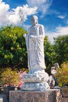 white Buddhist Buddha statue in park at Linh Ung Pagoda in Da Nang in Vietnam in summer in Asia photo