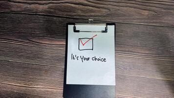 Concept of It's your choice write on paperwork isolated on wooden background. photo