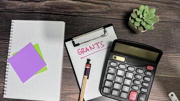 Concept of Grants write on paperwork isolated on wooden background. photo