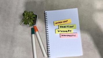 Concept of Leadership, Direction, Visionary, Dependability write on sticky notes isolated on Wooden Table. photo