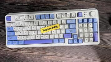 Concept of Requirement write on sticky notes isolated on Wooden Table. photo