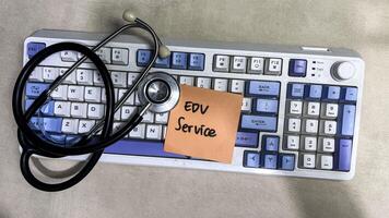 Concept of EDV Service write on paperwork isolated on wooden background. photo
