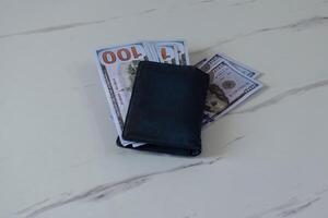 Blue wallet with dollars on table. Finance concept photo