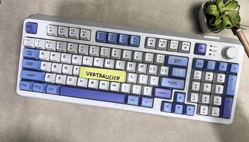 Concept of Vertraulich on German Language write on sticky notes isolated on Wooden Table. German Language it means Confidential photo