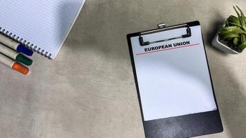 Concept of European Union write on paperwork isolated on wooden background. photo