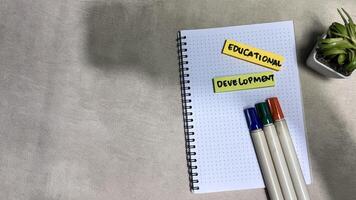 Concept of Educational Development write on sticky notes isolated on Wooden Table. photo