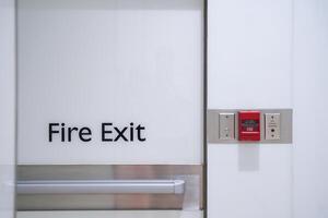 Fire exit sign with alarm system in modern building photo