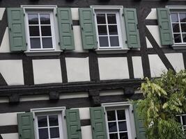 A building with green shutters and windows photo