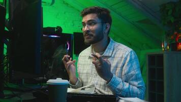 Worried Indian Arabian man guy streamer programmer hacker computer hope cross fingers loss failure error lost crypto freelancer crash studio home night male upset unhappy problem breaking monitor pc video