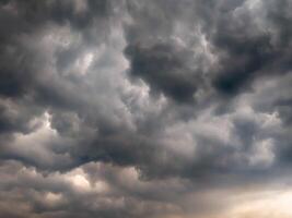 Dramatic storm clouds gathering in the sky, showcasing a powerful and moody atmosphere, ideal for weather-related themes and dramatic backgrounds. photo