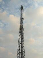 This image features a towering communication mast set against a backdrop of serene clouds, capturing the essence of technology blending seamlessly with the natural sky. photo