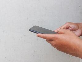 Hands engaged with a mobile phone, illustrating the seamless integration of technology into daily routines and the importance of staying connected. photo
