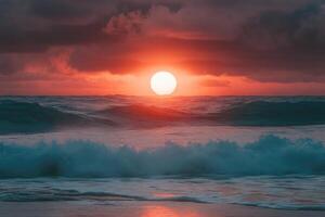 Big orange sun rising over ocean with crashing waves at beach during scenic sunrise photo