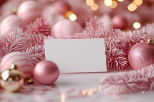 Blank white card displaying with pink christmas ornaments and garland photo