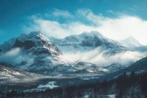 Majestic snow-capped mountain peaks rising above the clouds in a serene winter landscape photo