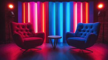 Two empty armchairs facing each other in a recording studio with colorful neon lights photo