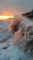 Big waves crashing on shore at sunset with cloudy sky and coastline photo