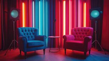 Two empty armchairs facing each other in a recording studio with colorful neon lights photo