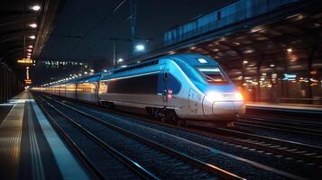 Modern high speed train arriving at railway station at night photo
