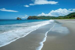Waves gently rolling onto a secluded beach in costa rica, lush green hills and white clouds photo