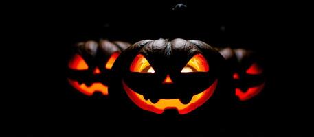 Jack-O'-Lantern With Glowing Eyes in the Dark photo