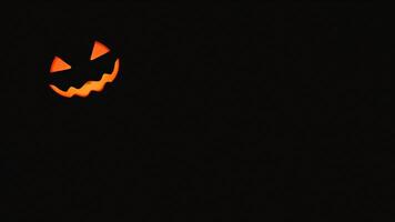 Jack-o'-lantern eyes glowing in the dark photo