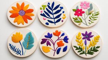 A beautiful set of round embroidered coasters featuring colorful floral and leaf patterns photo