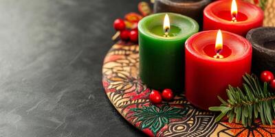 Kinara with red, green, and black candles on a dark table adorned with African patterns and holiday symbols photo