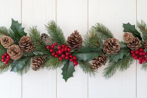 Rustic Christmas corner decorated with pine branches, red berries, and pinecones on a wooden background photo
